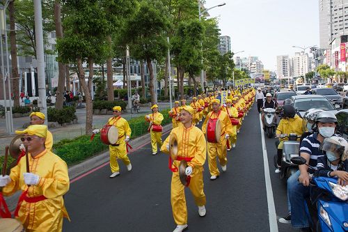 '圖7：二零一七年高雄法輪功學員慶祝即將來臨的「五一三世界法輪大法日」集會遊行，喜氣十足活潑親切的腰鼓隊壓軸，吸引了眾多路人放慢腳步駐足觀看。'